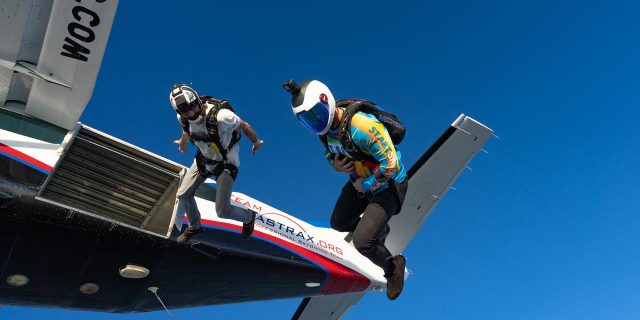 Two licensed jumpers exit the plane head down.