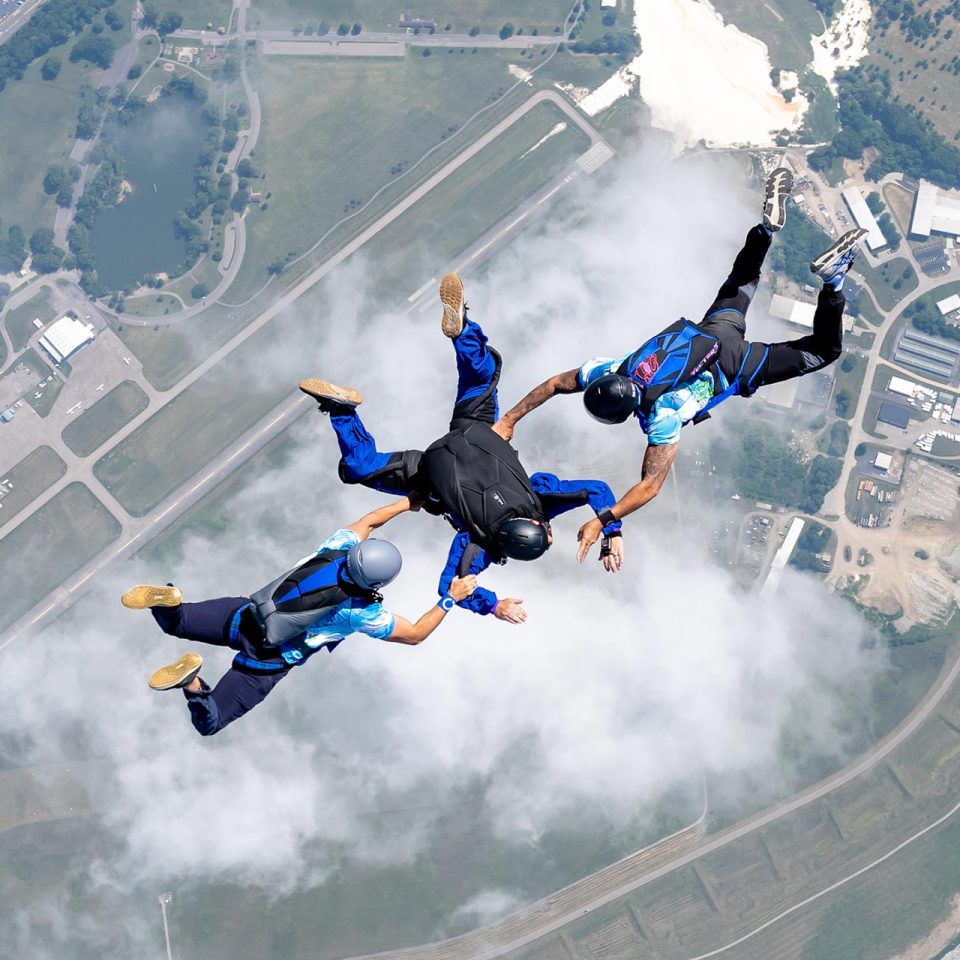 An skydiving AFF student with two instructors in freefall over Start Skydiving.