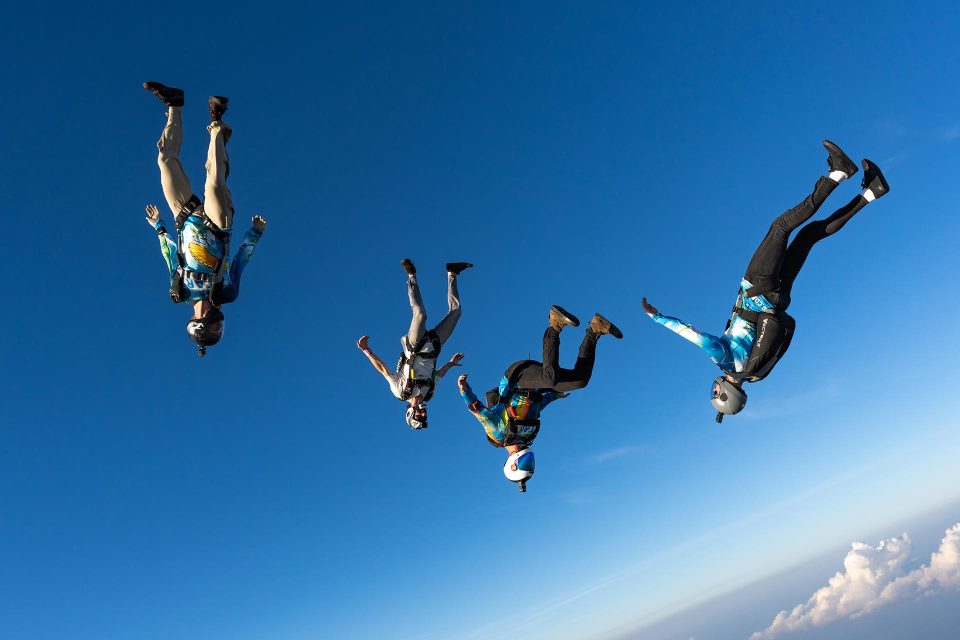 Group of licensed skydivers angle flying