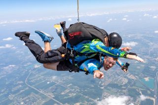 Male tandem skydiving pair in Start Skydiving gear smile with Ohio in the background.