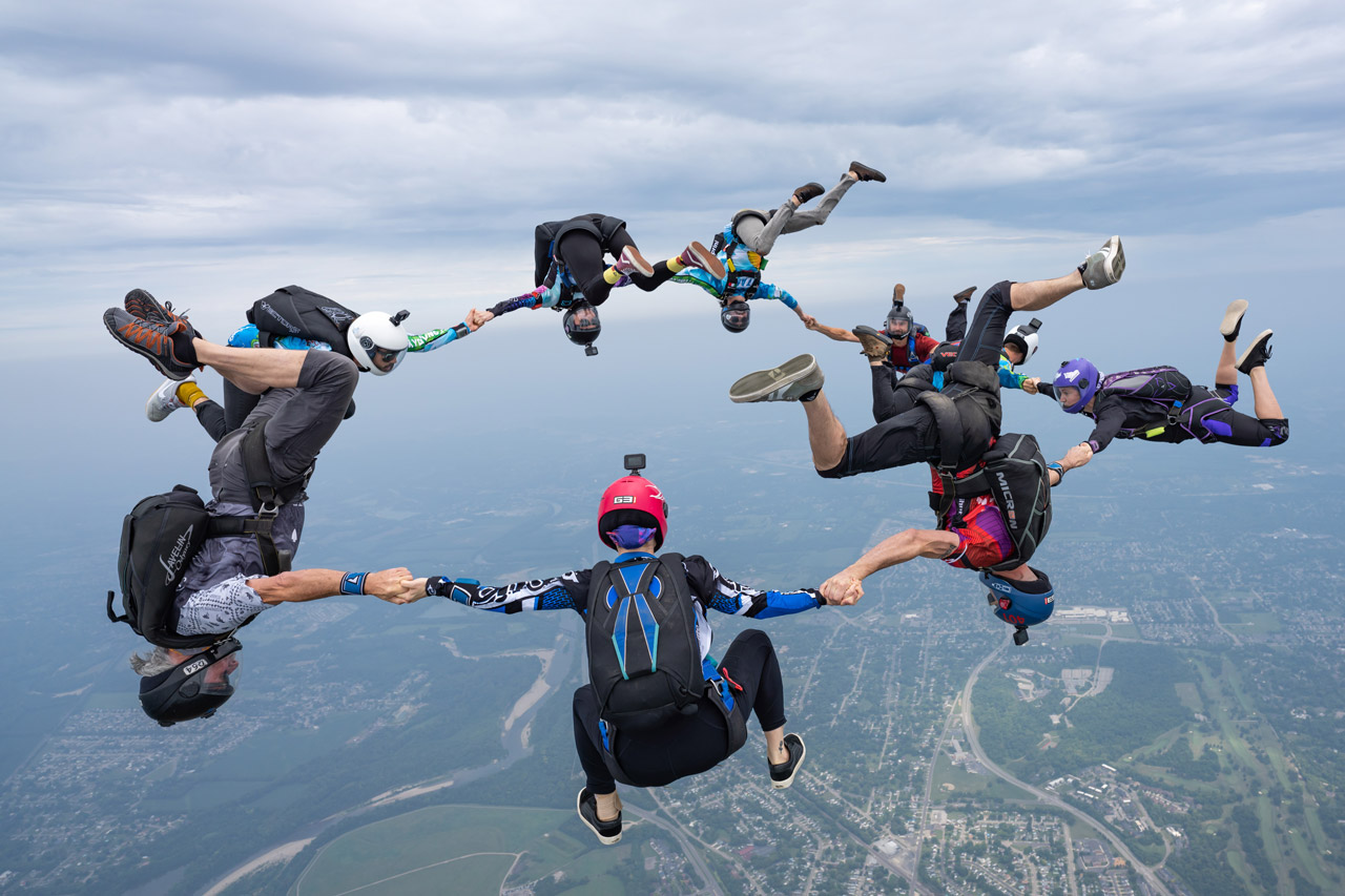 Circle of licensed skydivers captured mid transition while building a mixed orientation formation