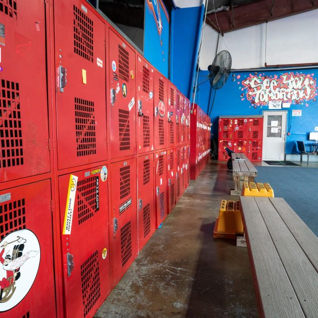 Two rows of red skydiving lockers within the Start Skydiving hangar