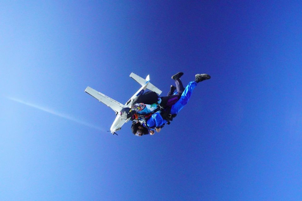 Tandem skydiving pair exiting from an aircraft