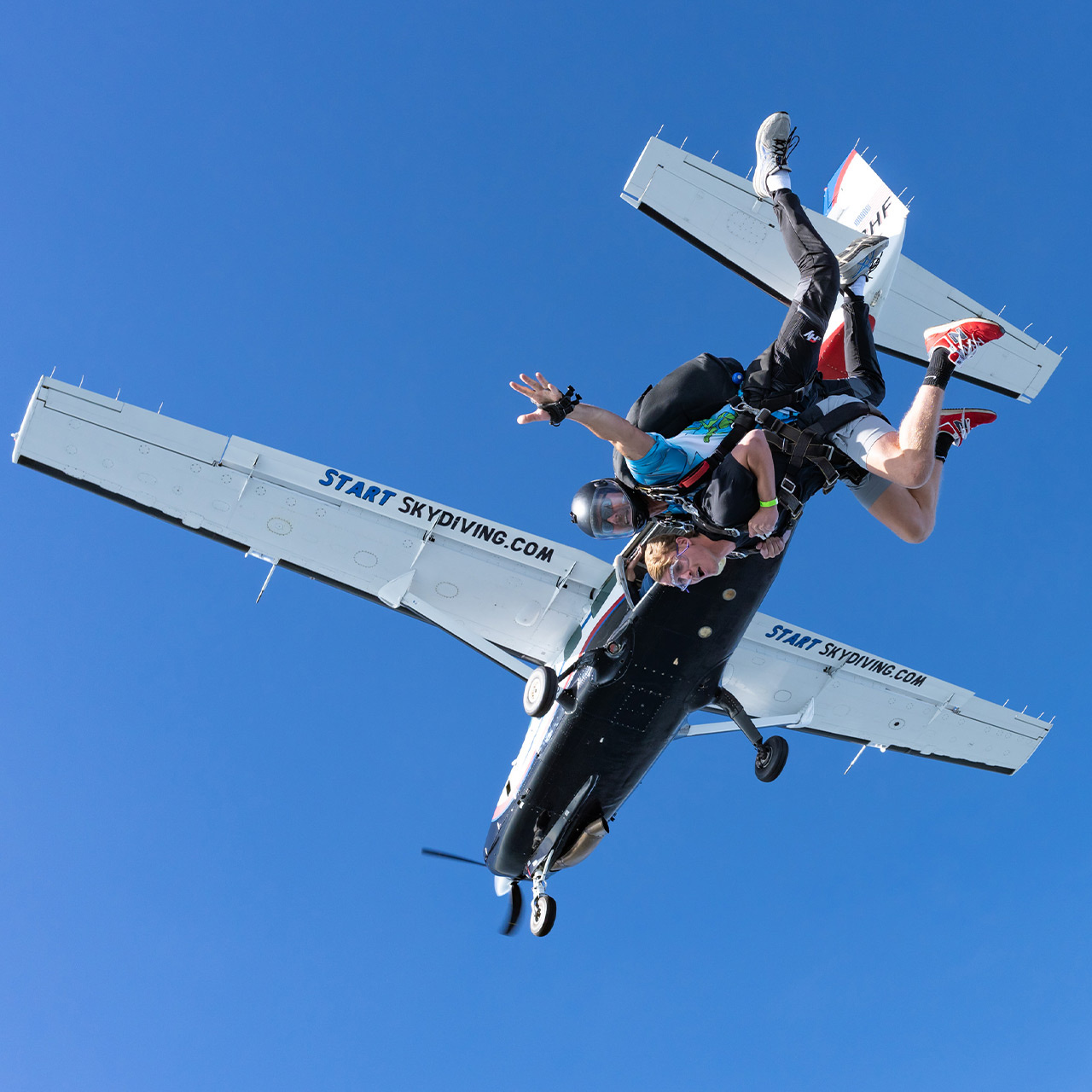 Excited tandem student and instructor exiting the aircraft during skydiving in Cincinnati