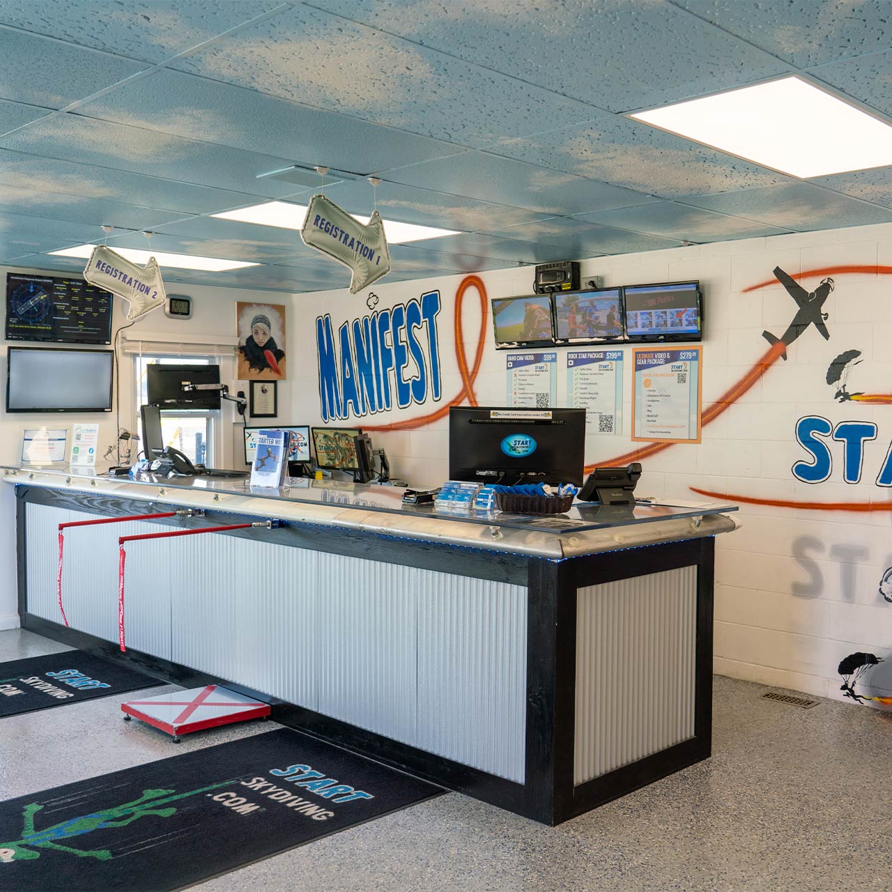 Manifest office at Start Skydiving with ceiling tiles painted to look like the sky