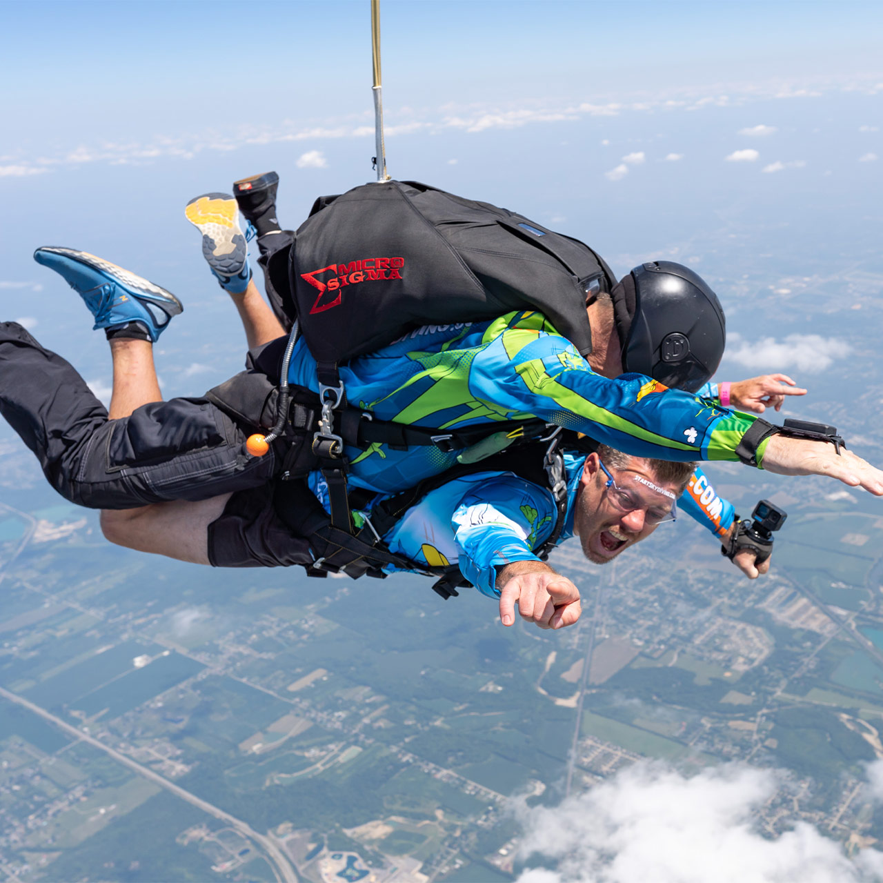 Male tandem skydiving pair in Start Skydiving gear smile with Ohio in the background.