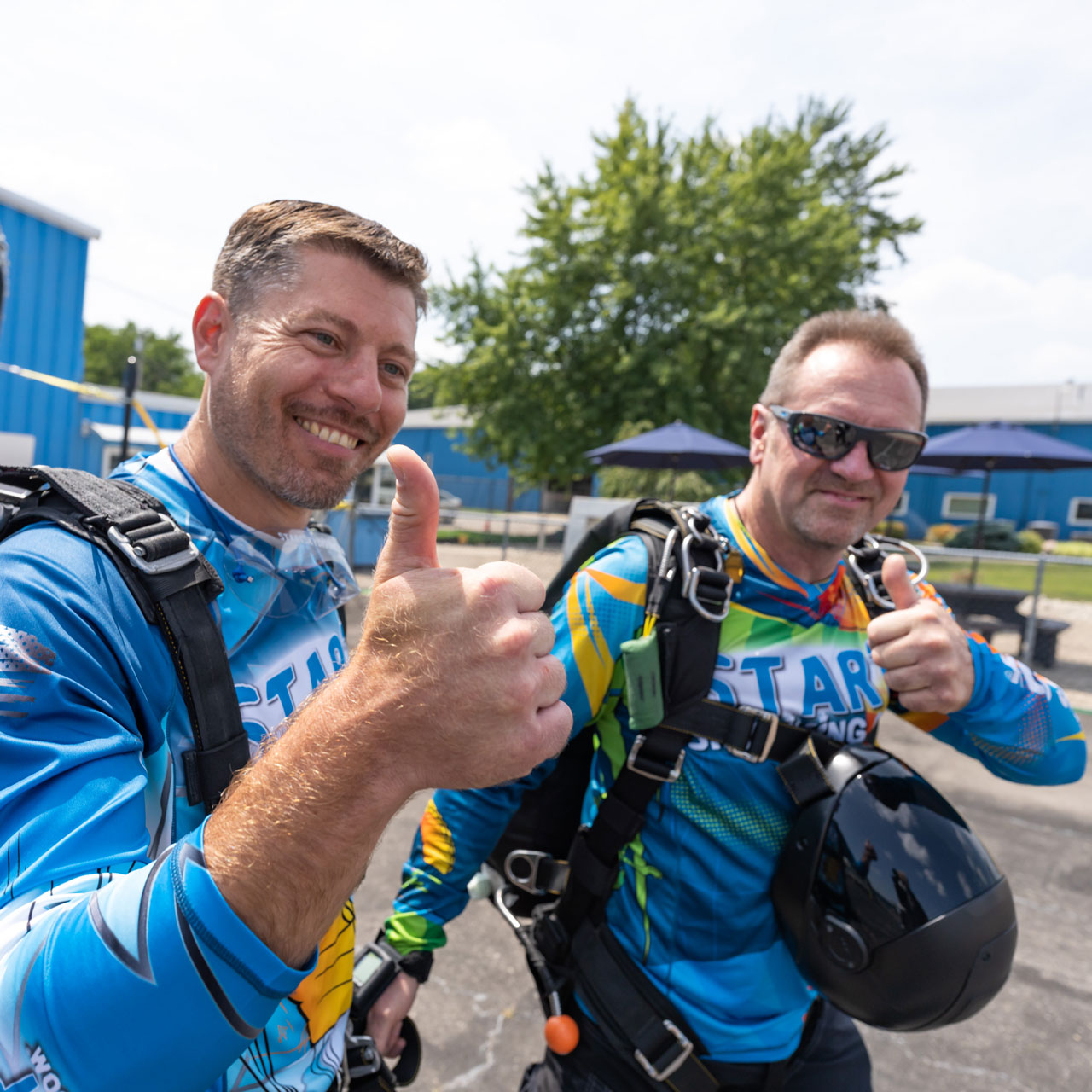 Tandem student and instructor give the camera a thumbs up before boarding the airplane.