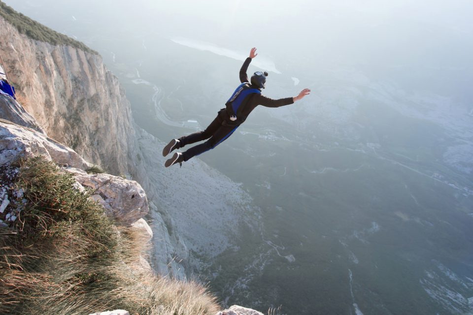BASE Jumper jumping off a mountain
